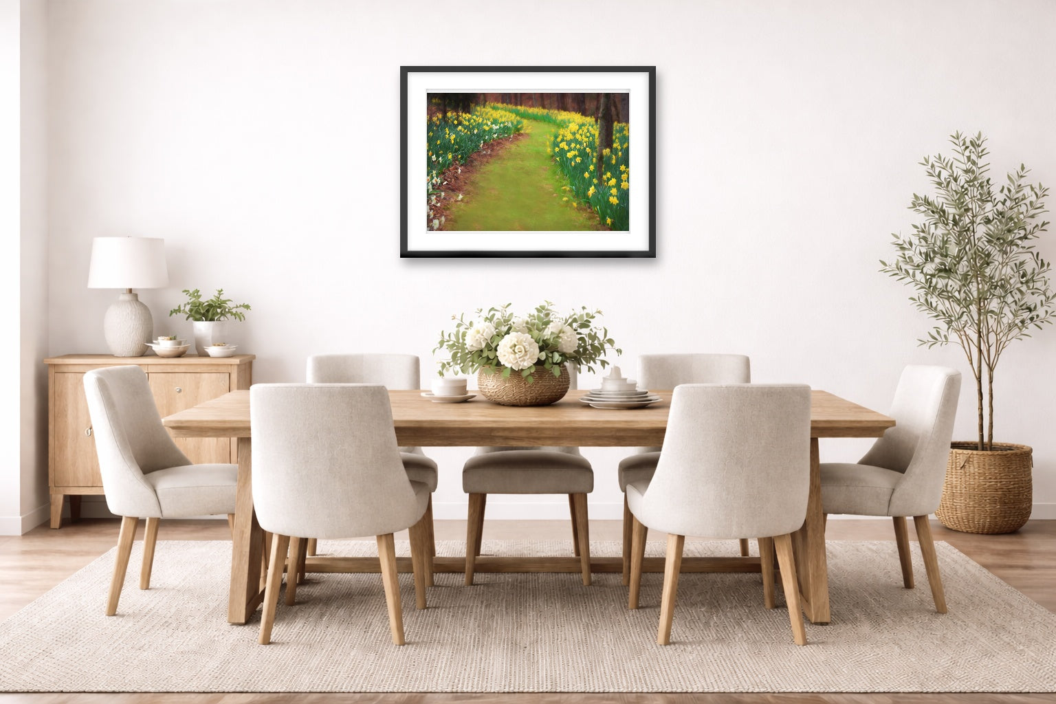 A black framed image hanging in a dining room with a wooden table and chairs,  and plants.