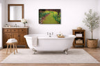 Canvas Print hanging in a  Bathroom with a freestanding bathtub, wooden cabinet, and decorative elements.