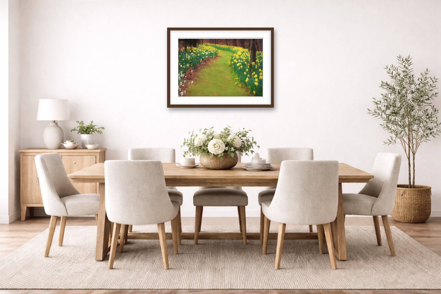 Dining room with a wooden table and chairs, and a espresso framed artwork, and plants.