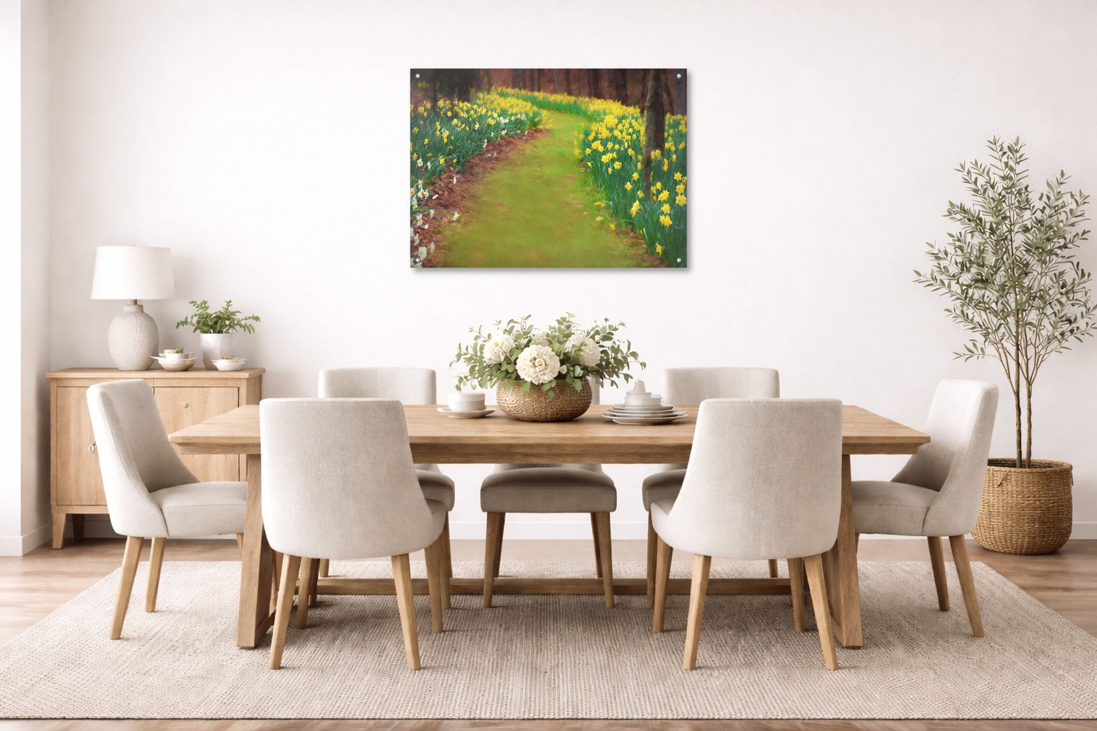 Dining room with wooden table and chairs, floral arrangement, and metal wall art of a garden path.