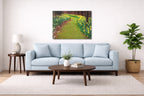 Metal print hanging in a living room with a light blue sofa, a wooden coffee table. Painting is of a garden path on the wall.