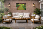 Outdoor Canvas hanging on a Paio Wall  with furniture and decor against a brick wall.