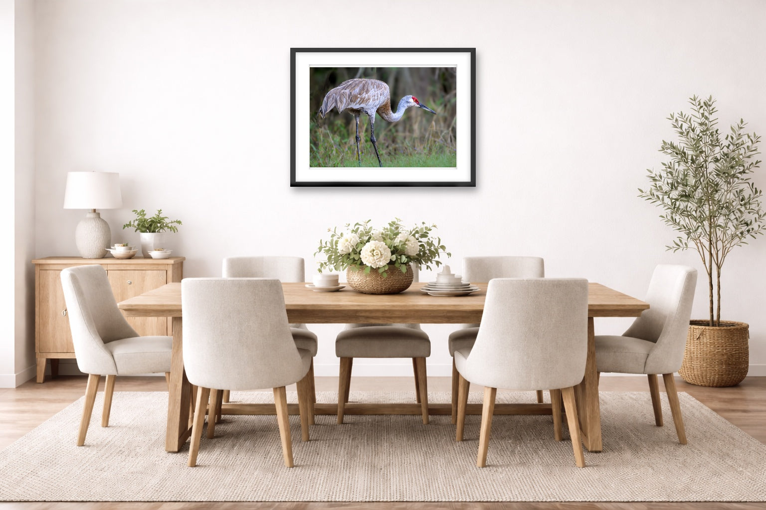 Majestic sandhill crane standing in Grass printed on fine art paper, framed on a black frame and matted and hung on a dining room wall.