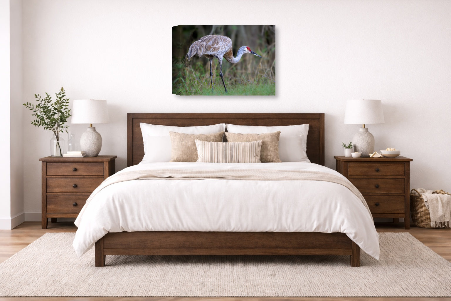 Majestic sandhill crane standing in Grass printed on canvas wall art displayed on a wall above a bed.