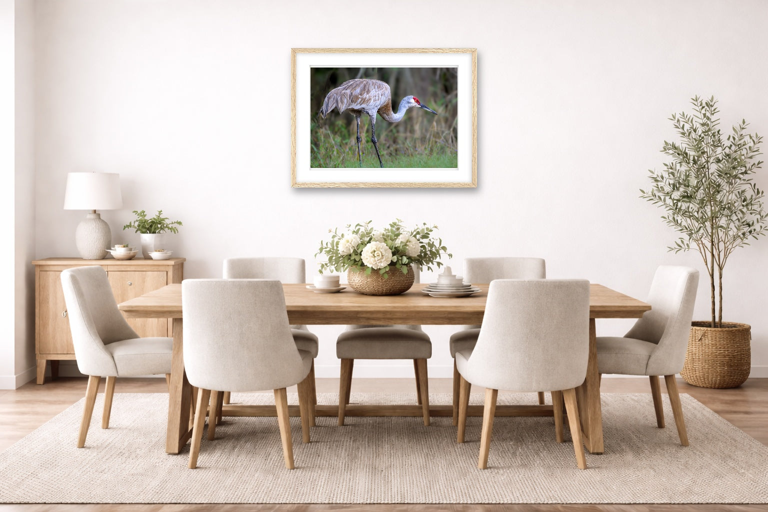 Majestic sandhill crane standing in Grass printed on fine art paper, framed on a oak frame and matted. Hung on a dining room wall.