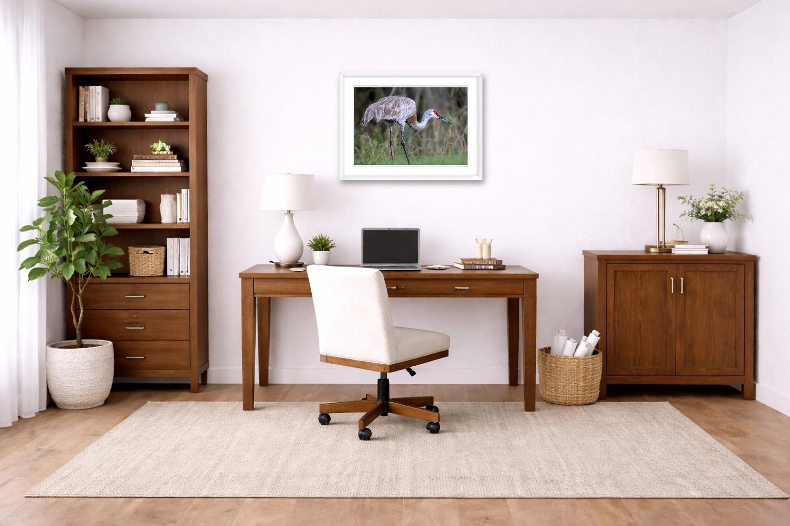Majestic sandhill crane standing in Grass printed on fine art paper, framed on a white frame and matted. Hung on a home office wall.