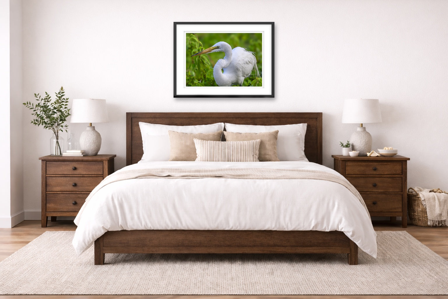 White Egret in Flight printed on fine art paper, framed on a black frame and matted and hung on a wall on an bedroom wall.