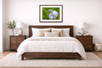 White Egret in Flight printed on fine art paper, framed on a espresso frame and matted. Hung on a living bedroom wall.