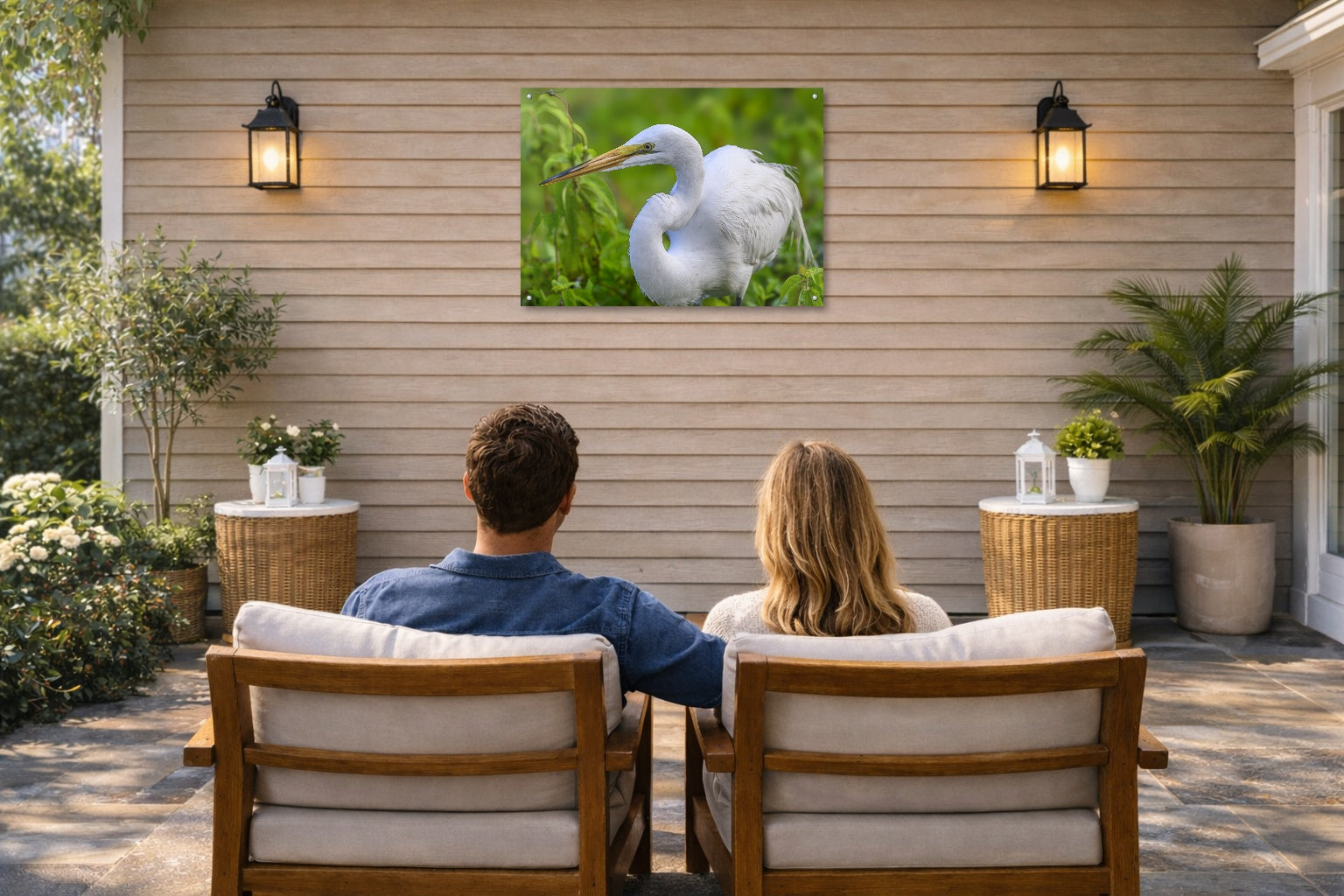 White Egret in Flight printed on water resistant canvas and mounted on a waterproof frame. Hung on a patio wall with couple.