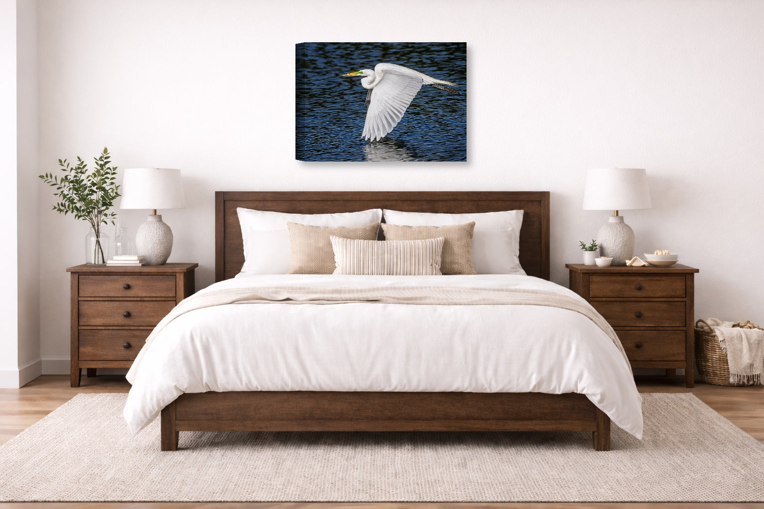 White Egret in Flight printed on canvas wall art displayed on a wall above a bed.