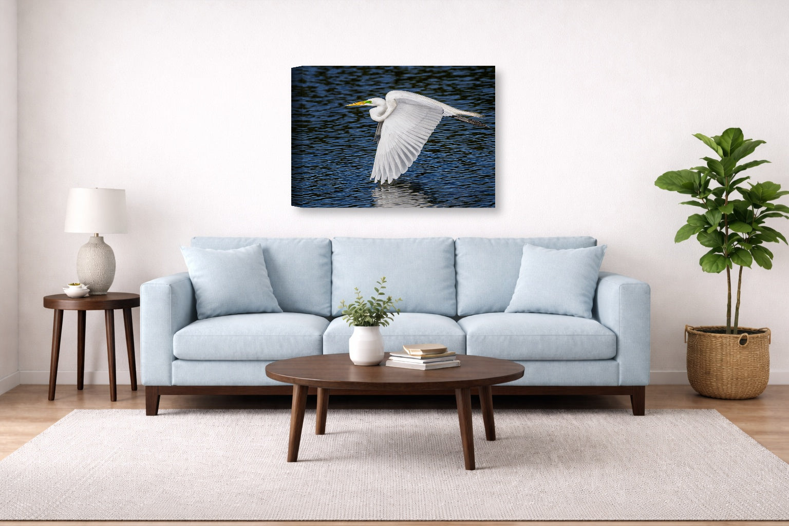 White Egret in Flight printed on canvas wall art displayed above a couch in a living room