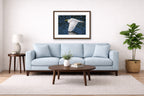 White Egret in Flight printed on fine art paper, framed on a espresso frame and matted. Hung on a living room wall