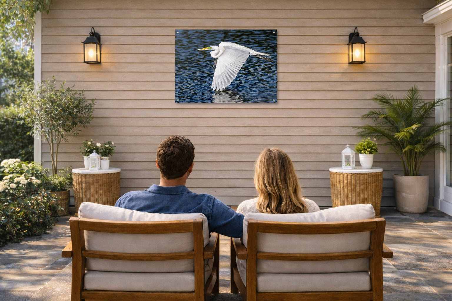 White Egret in Flight printed on water resistant canvas and mounted on a waterproof frame. Hung on a patio wall with couple.