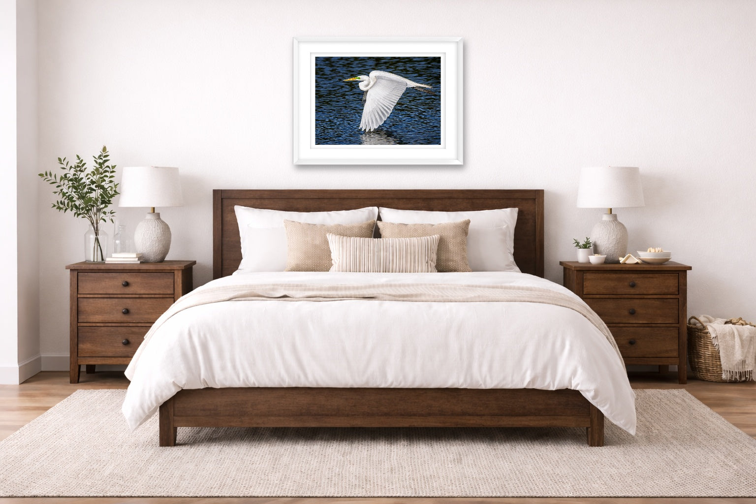 White Egret in Flight printed on fine art paper, framed on a white frame and matted. Hung on a bedroom room wall