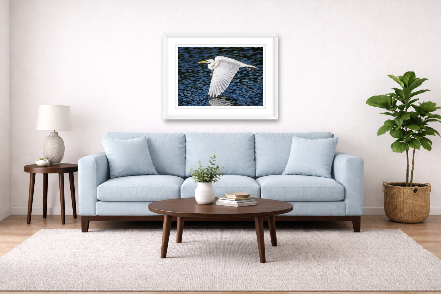 White Egret in Flight printed on fine art paper, framed on a white frame and matted. Hung on a living room wall.