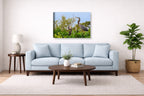 Blue Herons with Chicks printed on canvas wall art displayed above a couch in a living room
