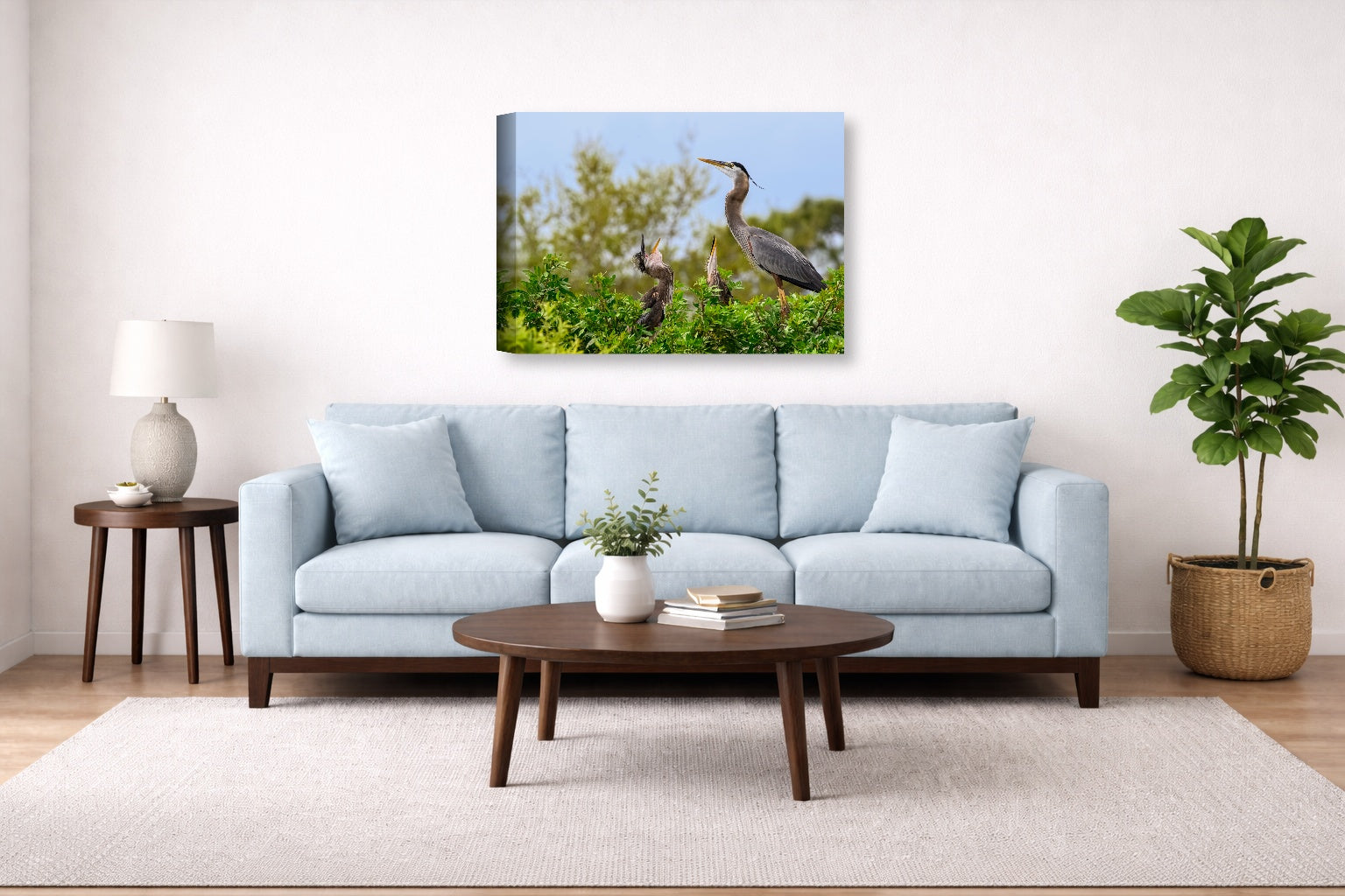 Blue Herons with Chicks printed on canvas wall art displayed above a couch in a living room