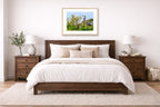 Blue Herons with Chicks printed on fine art paper, framed in a oak frame and matted. Hung on a bedroom wall.