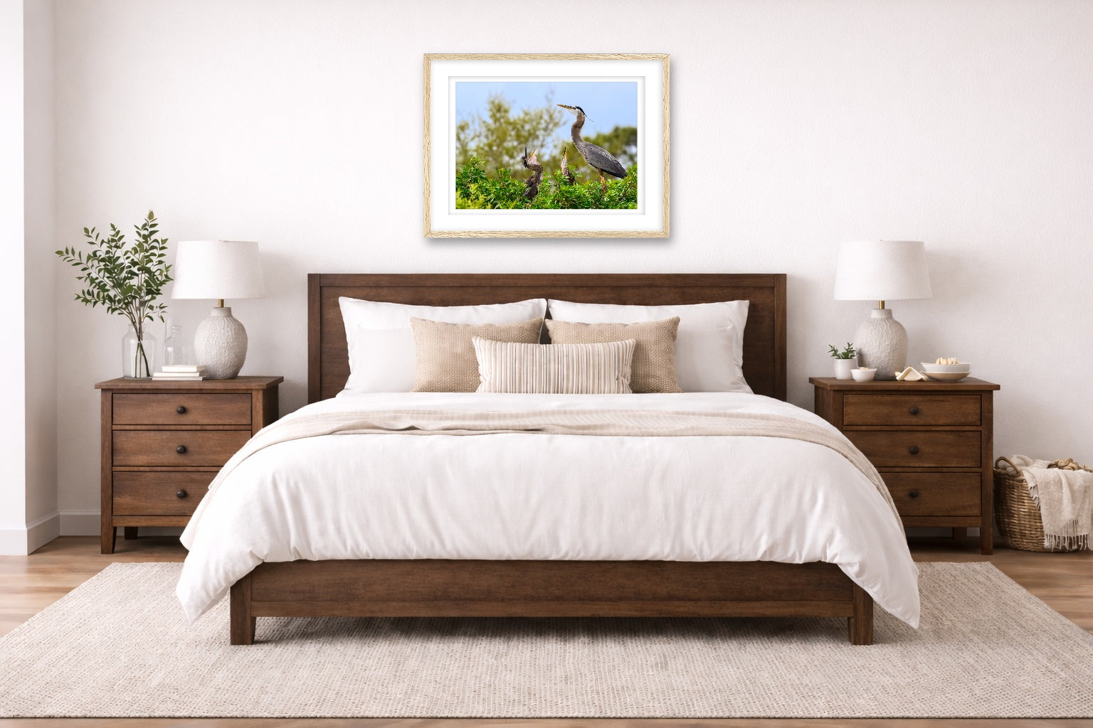 Blue Herons with Chicks printed on fine art paper, framed in a oak frame and matted. Hung on a bedroom wall.