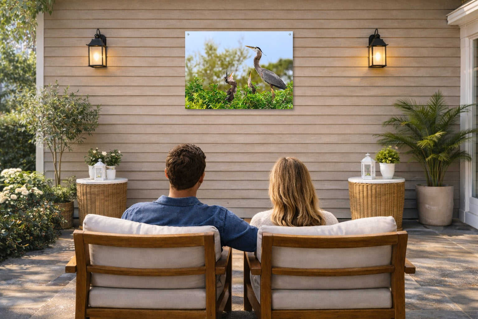 Blue Herons with Chicks printed on water resistant canvas and mounted on a waterproof frame. Hung on a patio wall with couple.
