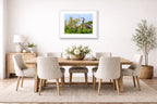 Blue Herons with Chicks printed on fine art paper, framed on a white frame and matted. Hung on a dining room wall.