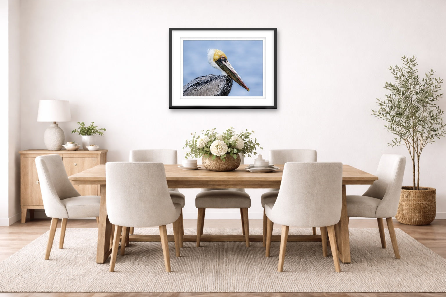Pelican Posing against a blue sky printed on fine art paper, framed on a black frame and matted and hung on a dining room wall.
