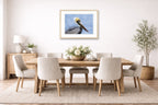 Pelican Posing against a blue sky printed on fine art paper, framed on a oak frame and matted. Hung on a dining room wall.