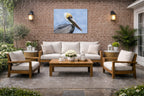 Pelican Posing against a blue sky printed on water resistant canvas and mounted on a waterproof frame. Hung on a patio wall.