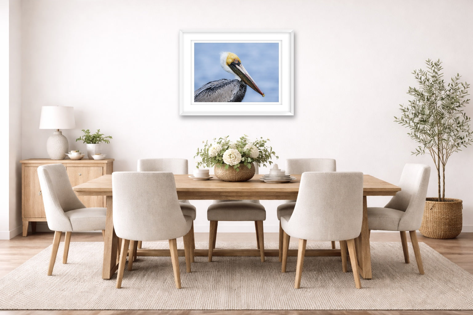 Pelican Posing against a blue sky printed on fine art paper, framed on a white frame and matted. Hung on a dining room wall.