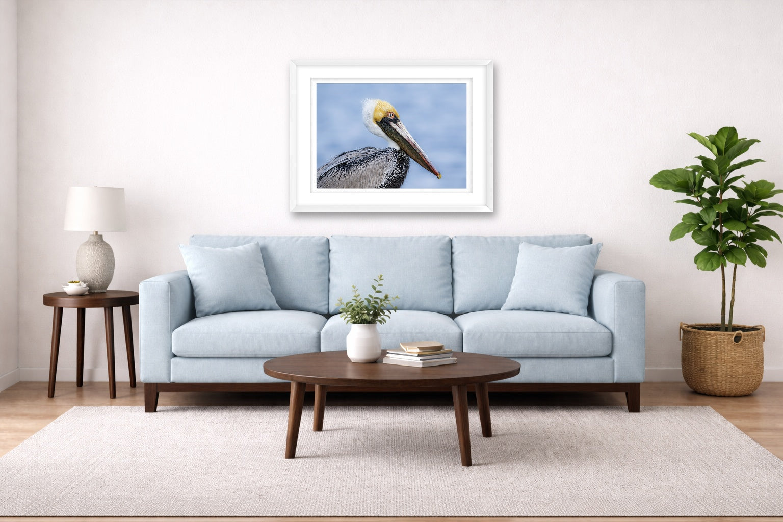 Pelican Posing against a blue sky printed on fine art paper, framed on a white frame and matted. Hung on a living room wall.