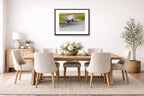 Blue Heron in Flight printed on fine art paper, framed on a black frame and matted and hung on a dining room wall.