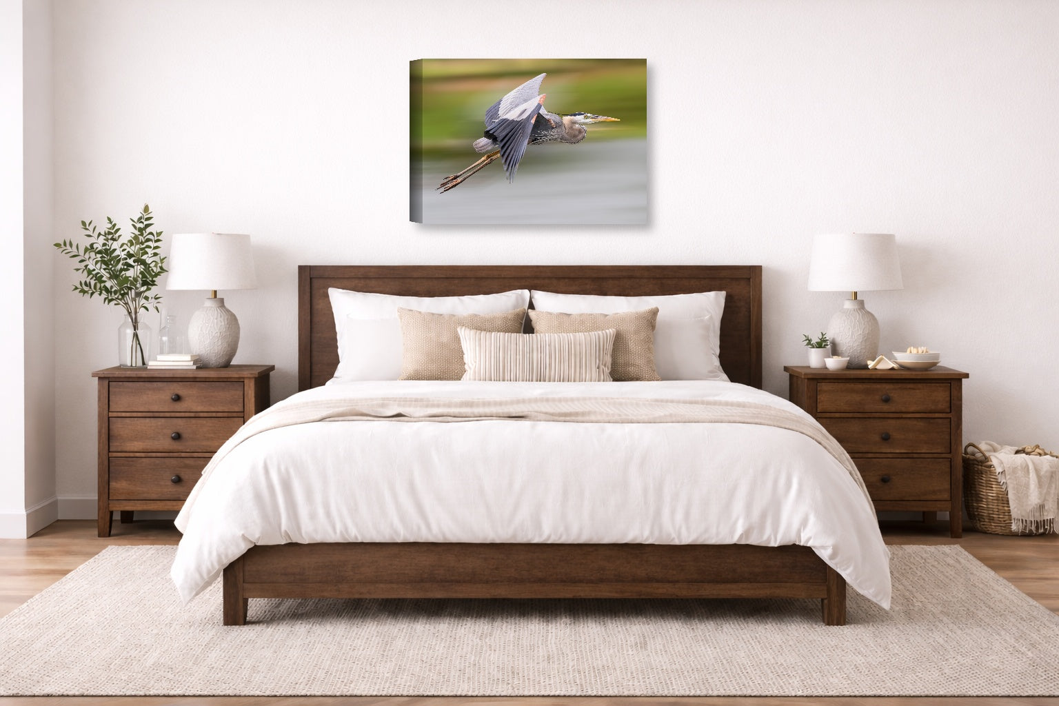 Blue Heron in Flight printed on canvas wall art displayed on a wall above a bed.