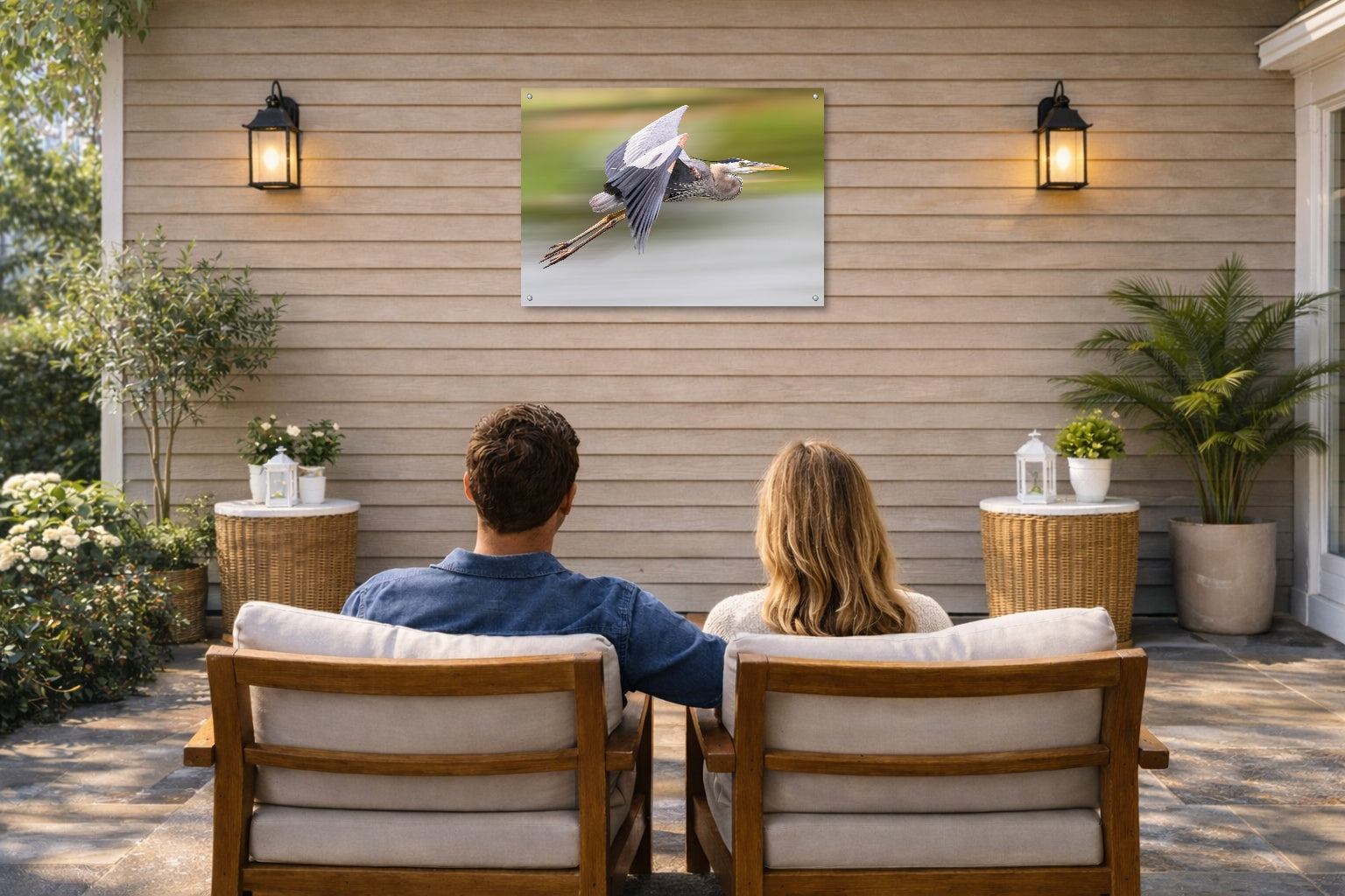 Blue Heron in Flight printed on water resistant canvas and mounted on a waterproof frame. Hung on a patio wall with couple.