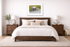 Blue Heron in Flight printed on fine art paper, framed on a white frame and matted. Hung on a bedroom room wall