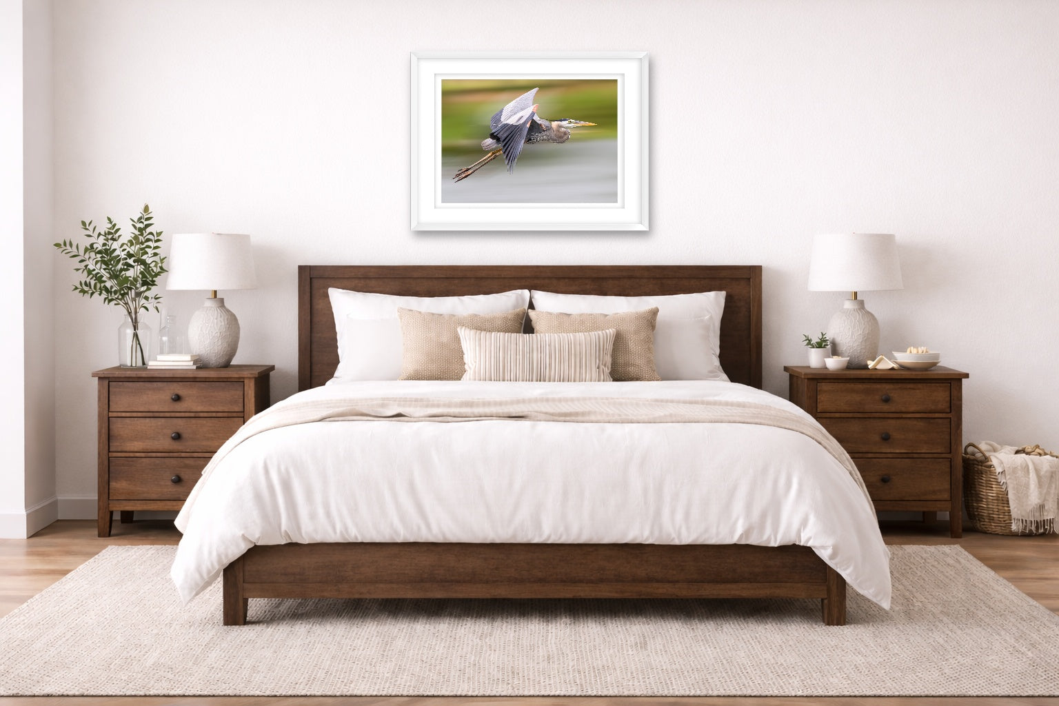 Blue Heron in Flight printed on fine art paper, framed on a white frame and matted. Hung on a bedroom room wall