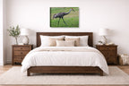 Sandhill Crane - Walking printed on canvas wall art displayed on a wall above a bed.