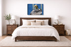Preening Pelican printed on canvas wall art displayed on a wall above a bed.