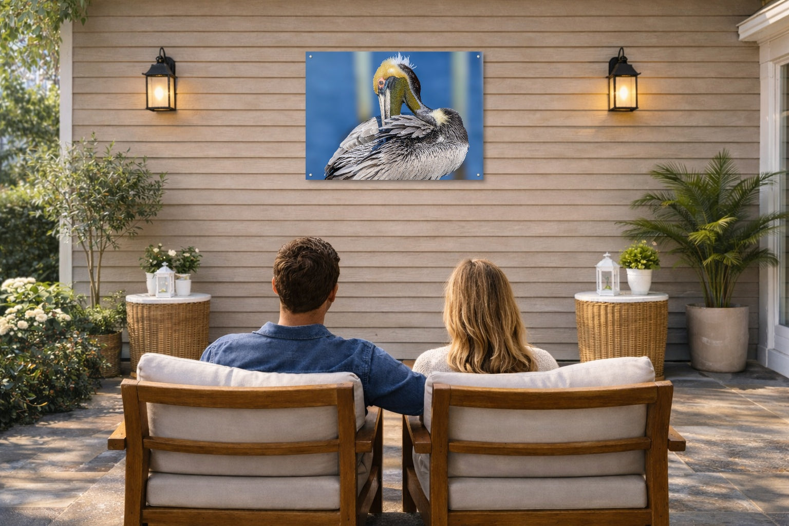 Preening Pelican printed on water resistant canvas and mounted on a waterproof frame. Hung on a patio wall with couple.