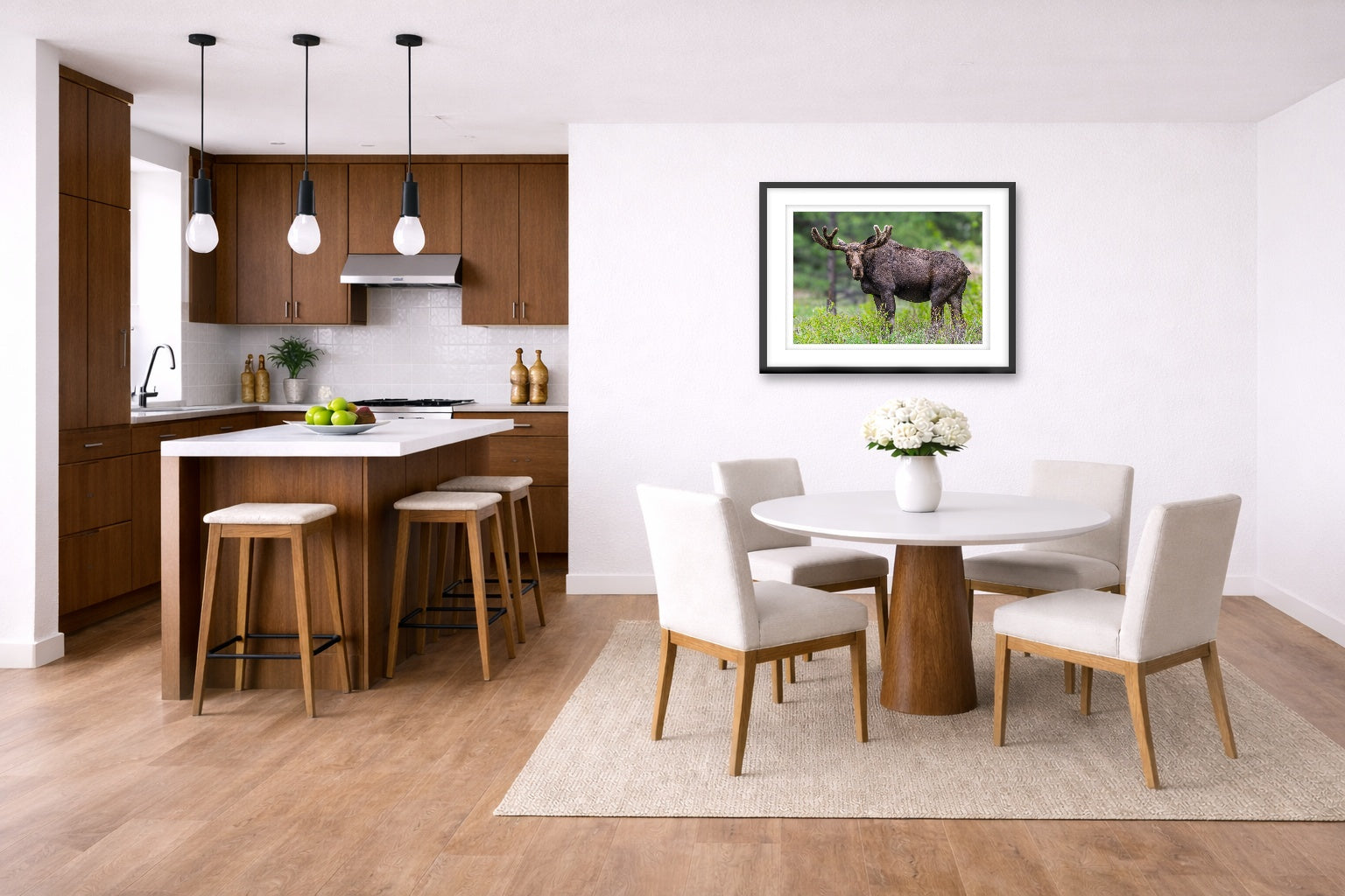 Moose in the Rockies printed on fine art paper, framed on a black frame and matted and hung on a wall on a dinette wall.