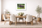 Moose in the Rockies printed on fine art paper, framed on a white frame and matted. Hung on a dining room wall.