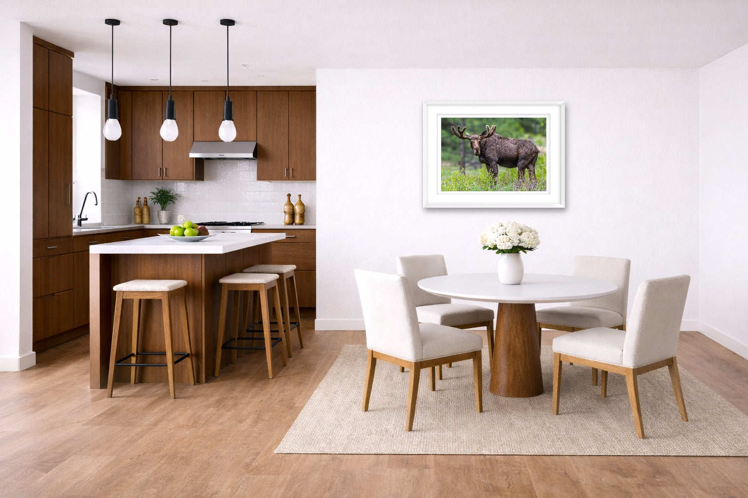 Moose in the Rockies printed on fine art paper, framed on a white frame and matted. Hung on a kitchen-dinette wall.