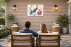 Blue Heron - Geometric Painting printed on water resistant canvas and mounted on a waterproof frame. Hung on a patio wall with couple.