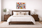 Colorful Geometric Abstract Botanical printed on canvas wall art displayed on a wall above a bed.