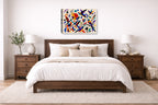 Geometric Bird Painting printed on canvas wall art displayed on a wall above a bed.