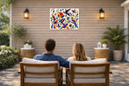 Geometric Bird Painting printed on water resistant canvas and mounted on a waterproof frame. Hung on a patio wall with couple.