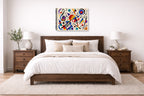 Geometric Abstract Musical Painting printed on canvas wall art displayed on a wall above a bed.