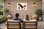 Geometric Painting of an Eagle Landing printed on water resistant canvas and mounted on a waterproof frame. Hung on a patio wall with couple.