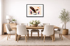 Geometric Painting of an Eagle Catching a Fish printed on fine art paper, framed on a black frame and matted and hung on a dining room wall.