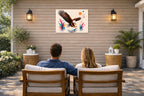 Geometric Painting of an Eagle Catching a Fish printed on water resistant canvas and mounted on a waterproof frame. Hung on a patio wall with couple.