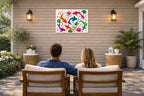 Koi Fish - Geometric Painting printed on water resistant canvas and mounted on a waterproof frame. Hung on a patio wall with couple.